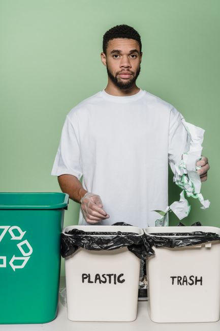 A person, wearing a white jacket, is reaching out with their right hand towards a sign on the side of a purple mobile unit, possibly a van or trailer used in house removals or relocation services. The